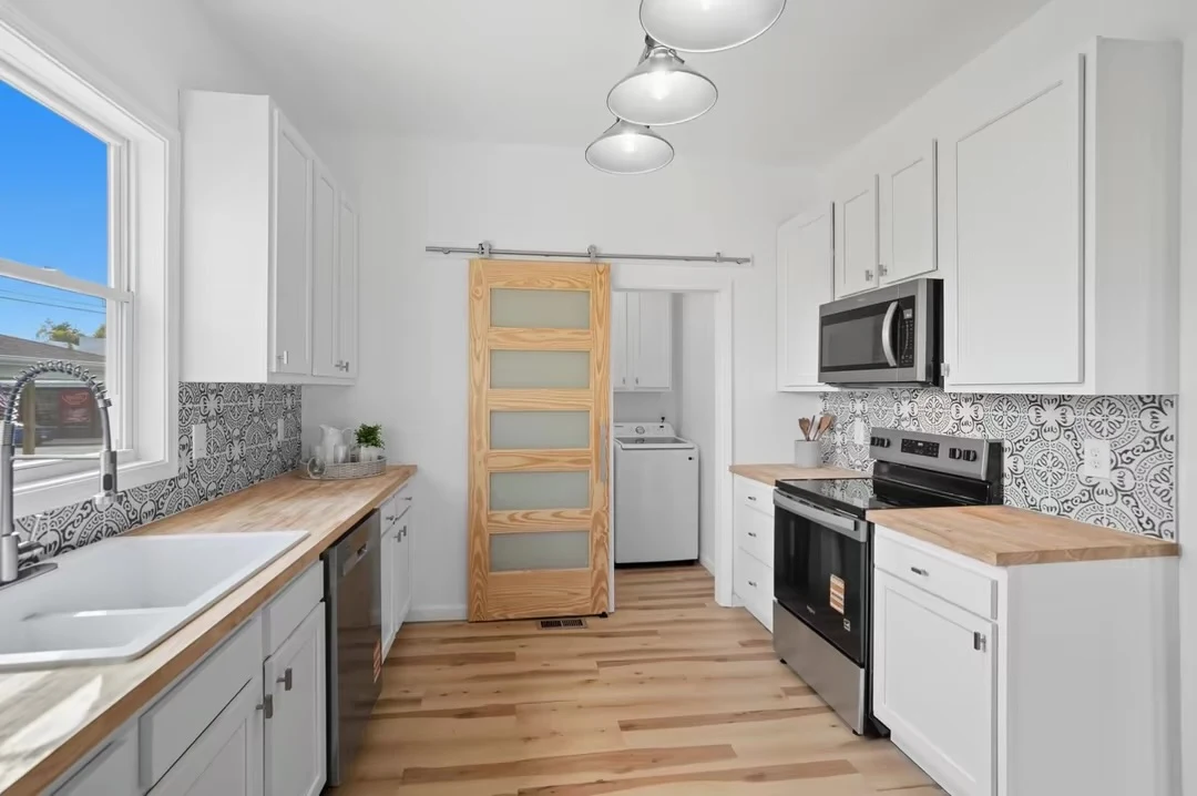 Kitchen with sliding wood door and coordinated finishes