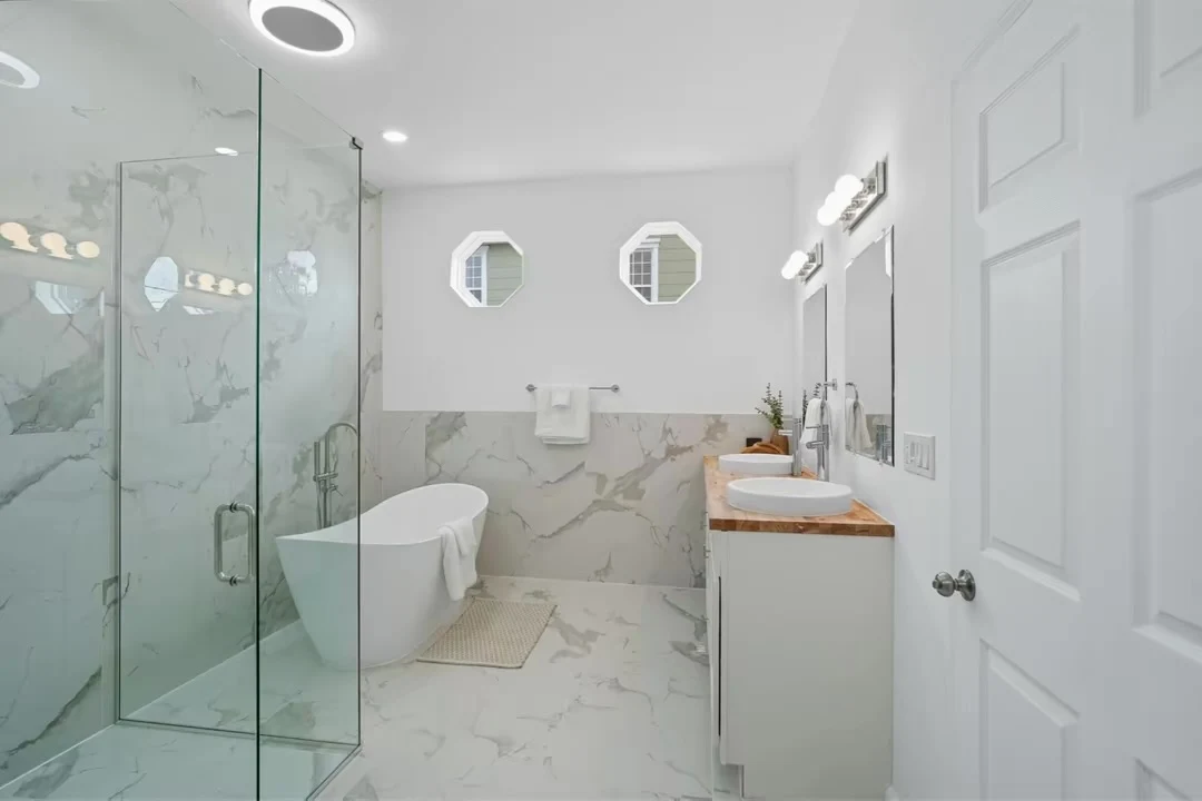 Glass shower and marble-look wall and floor finishes