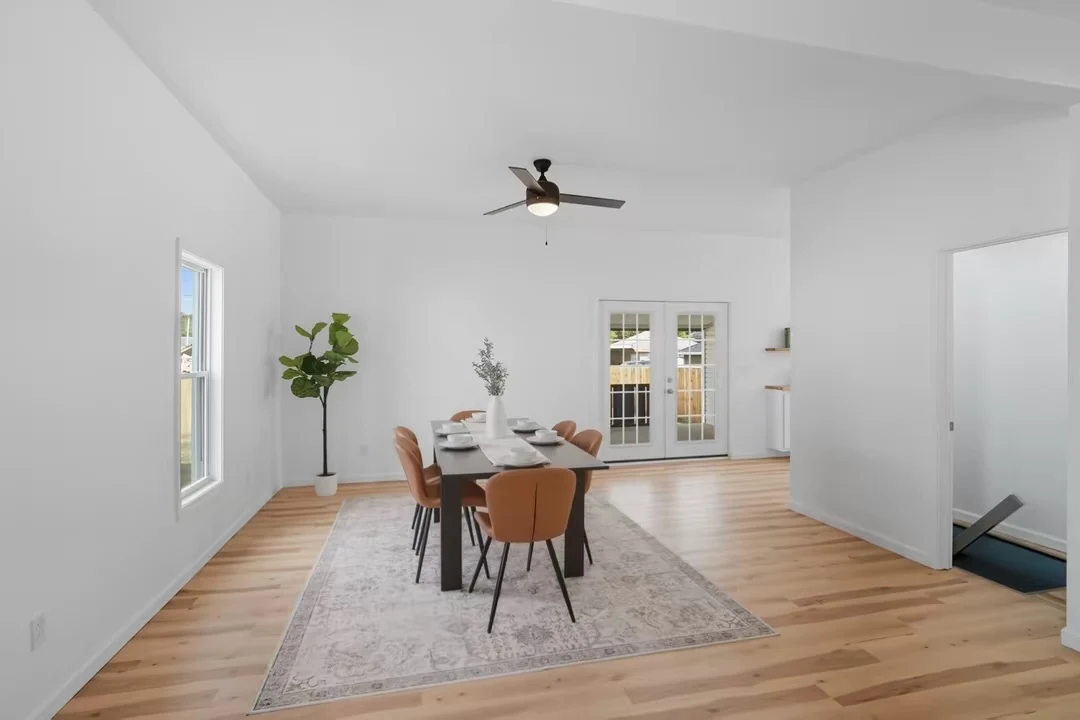 Bright dining room with wood flooring and French doors